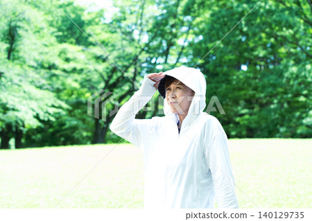 Senior women exercising while using UV protection. Senior women exercising while using UV protection. 140129735