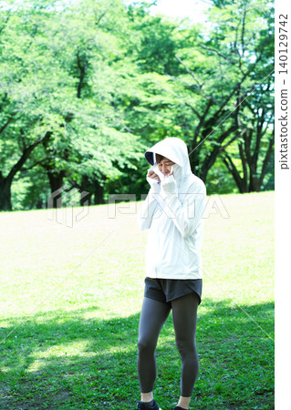 Senior women exercising while using UV protection. Senior women exercising while using UV protection. 140129742