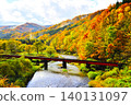 Railway bridge amidst autumn foliage 140131097