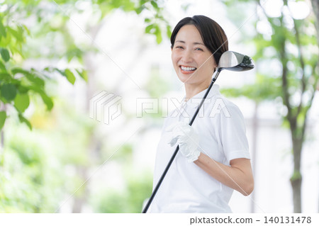 Smiling woman playing golf Smiling woman playing golf 140131478