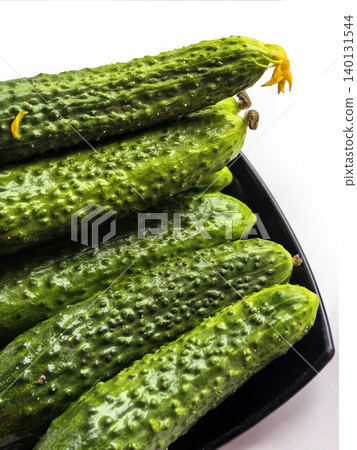 Fresh Cucumbers On Black Plate Close Up Fresh Cucumbers On Black Plate Close Up 140131544