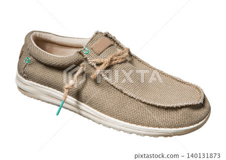 Men's casual canvas shoes isolated on a white background. Beige textile loafers with a textured sole, side view. Men's casual canvas shoes isolated on a white background. Beige textile loafers with a textured sole, side view. 140131873