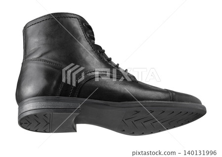 Men black leather boots isolated on white background. Casual winter lace-up ankle boots with cap toe and rubber sole, side bottom view. Men black leather boots isolated on white background. Casual winter lace-up ankle boots with cap toe and rubber sole, side bottom view. 140131996