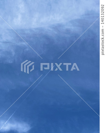 A sky with a contrail rising to the right. A sky with a contrail rising to the right. 140132092