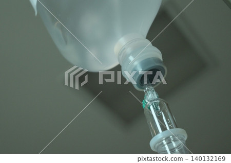 saline solution drip for patient and infusion pump in hospital, close up equipment of medicine 140132169