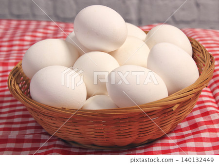 Basket of Farm Fresh Eggs on Red and White Checkered Fabric Basket of Farm Fresh Eggs on Red and White Checkered Fabric 140132449