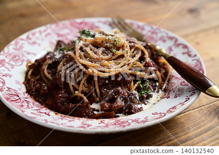 Venison stewed in wine and served with pasta Venison stewed in wine and served with pasta 140132540
