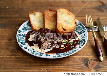 Venison stewed in red wine 140132548