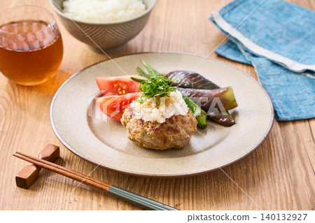 Japanese-style hamburger steak topped with grated daikon radish and shiso leaves Japanese-style hamburger steak topped with grated daikon radish and shiso leaves 140132927