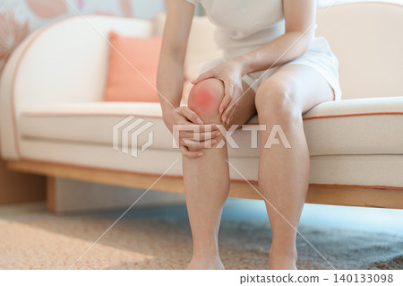 woman having knee ache and muscle pain due to Runners Knee or Patellofemoral Pain Syndrome, osteoarthritis, arthritis, rheumatism and Patellar Tendinitis. health and medical concept 140133098