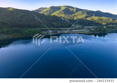 A beautiful early morning view of Lake Aoki in Omachi City, Nagano Prefecture (aerial photograph taken by drone) 140133435