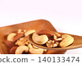 Mixed nuts served in a bowl and spoon 140133474