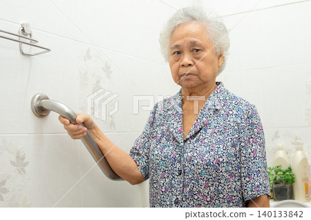 Asian elderly woman use toilet bathroom handle security, healthy strong medical concept. Asian elderly woman use toilet bathroom handle security, healthy strong medical concept. 140133842