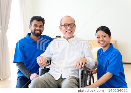 Multinational caregivers watch over seniors with smiles. Multinational caregivers watch over seniors with smiles. 140134021