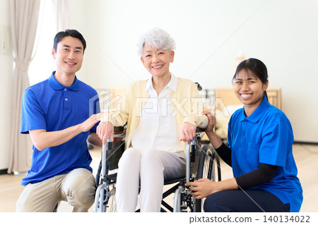 Multinational caregivers watch over seniors with smiles. Multinational caregivers watch over seniors with smiles. 140134022
