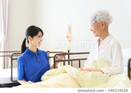 Seniors and caregivers conversing in a nursing home Seniors and caregivers conversing in a nursing home 140134026