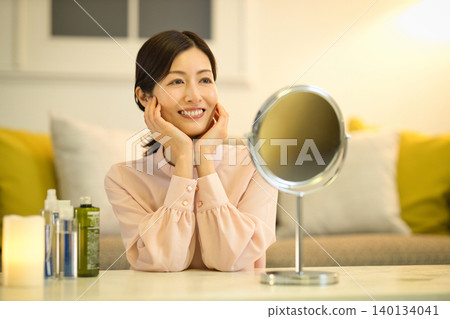 Middle-aged women doing their nighttime skincare routine Middle-aged women doing their nighttime skincare routine 140134041