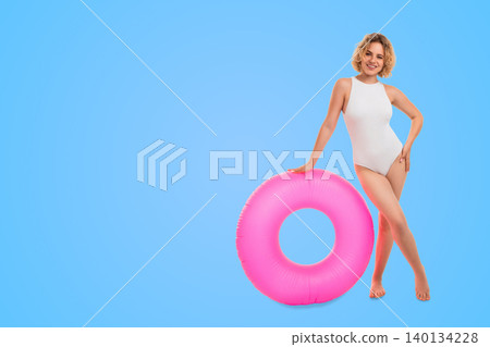 Woman poses with pink float ring. Summer fashion and tropical mood concept 140134228