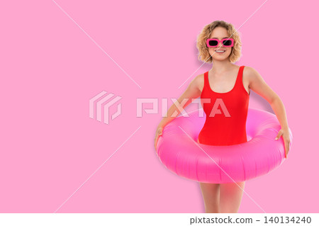 Woman holds pink floatie. Summer joy and playful spirit concept 140134240