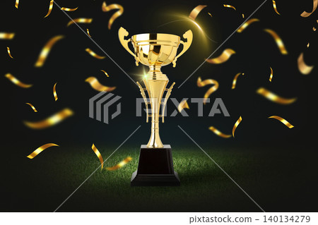 Golden trophy stands on a pedestal with confetti around it 140134279