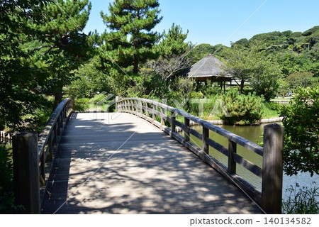 Yokohama City: Bridge, large pond, and gazebo at Sankeien Garden. Yokohama City: Bridge, large pond, and gazebo at Sankeien Garden. 140134582