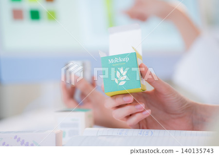 Hand holding cosmetic packaging mockup box, graphic designer and development branding project. Hand holding cosmetic packaging mockup box, graphic designer and development branding project. 140135743