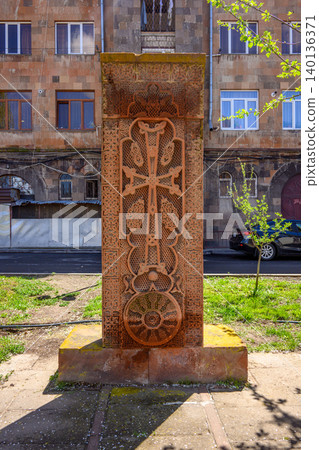 Historic Armenian khachkar stands amidst city greenery Historic Armenian khachkar stands amidst city greenery 140136371