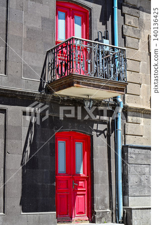 Two red doors, one on balcony, one at ground level Two red doors, one on balcony, one at ground level 140136425