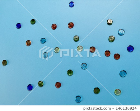 Marbles scattered against a blue background Marbles scattered against a blue background 140136924