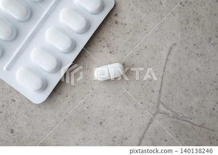 Medical pills and drugs in white package and one pill on the stone background. Healthcare concept. Space for text. Medical pills and drugs in white package and one pill on the stone background. Healthcare concept. Space for text. 140138246
