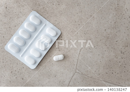 Much medical pills in white package and one pill on the stone table background. Healthcare concept. Space for text. Much medical pills in white package and one pill on the stone table background. Healthcare concept. Space for text. 140138247