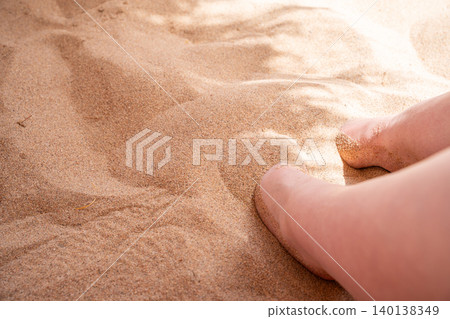 Bare feet press into soft beach sand in Sharm El Sheikh Egypt with close view of texture and sunlight on the Red Sea coast. Beach relaxation and resort lifestyle Bare feet press into soft beach sand in Sharm El Sheikh Egypt with close view of texture and sunlight on the Red Sea coast. Beach relaxation and resort lifestyle 140138349