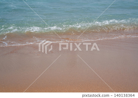 Gentle sea waves reach a sandy beach in Sharm El Sheikh Egypt with clear water along the Red Sea coastline in daylight. Beach resort lifestyle Gentle sea waves reach a sandy beach in Sharm El Sheikh Egypt with clear water along the Red Sea coastline in daylight. Beach resort lifestyle 140138364