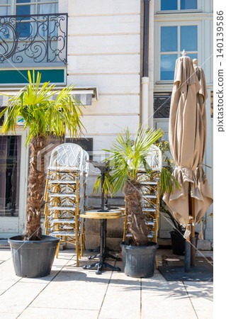 Warehouse on the open air. Chairs and tables outside on the spring sun weather. Furnitureset for close summer cafe in France. 140139586