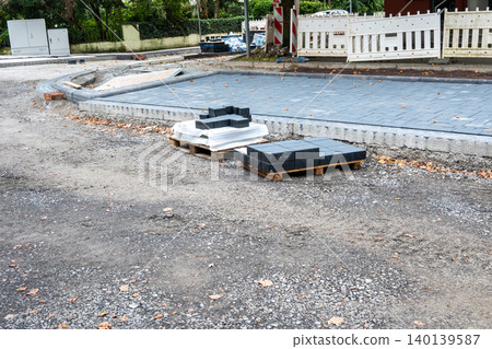 Pavement tiles for road sidewalk repair near houses. Construction process and urban infrastructure in big city. Pavement tiles for road sidewalk repair near houses. Construction process and urban infrastructure in big city. 140139587