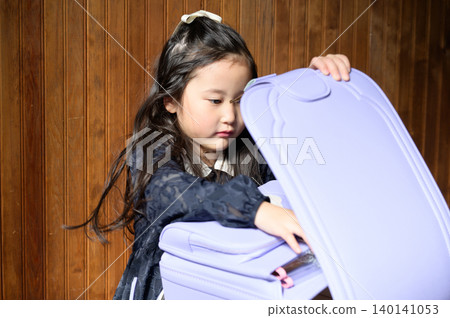 A Japanese girl opening her schoolbag A Japanese girl opening her schoolbag 140141053