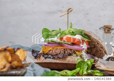 Healthy vegan burger with fresh vegetables and yogurt sauce Healthy vegan burger with fresh vegetables and yogurt sauce 140141369