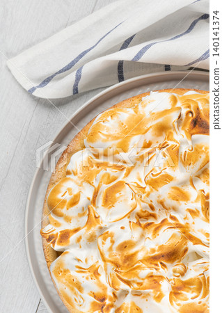 Lemon tart pie with meringue cream. Traditional American cake. Homemade baking. Copy space Lemon tart pie with meringue cream. Traditional American cake. Homemade baking. Copy space 140141374