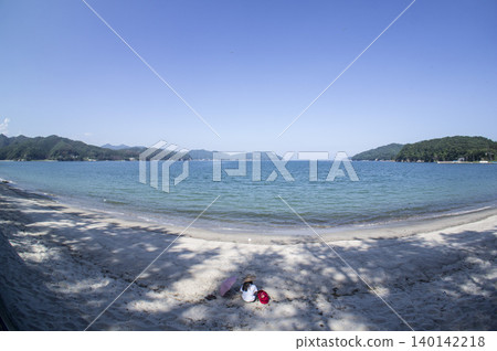 A woman standing on the beach A woman standing on the beach 140142218
