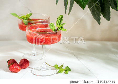 Refreshing strawberry frozen margaritas with fresh mint Refreshing strawberry frozen margaritas with fresh mint 140142245