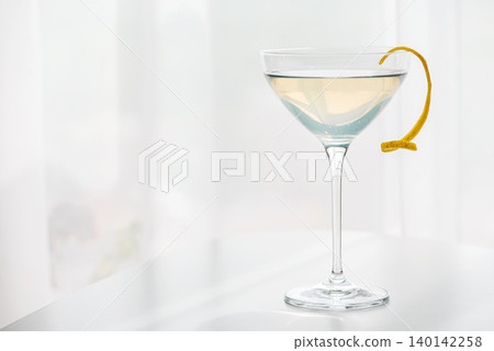 French 75 cocktail serving with lemon twist garnish French 75 cocktail serving with lemon twist garnish 140142258