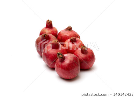 Ripe red pomegranates on a white background Ripe red pomegranates on a white background 140142422