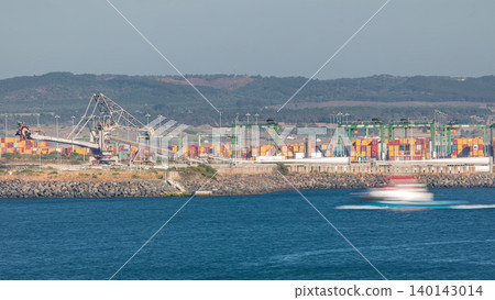Aerial view of container cargo terminal of commercial port timelapse, business logistics and transport industry in Sines, Portugal. Aerial view of container cargo terminal of commercial port timelapse, business logistics and transport industry in Sines, Portugal. 140143014
