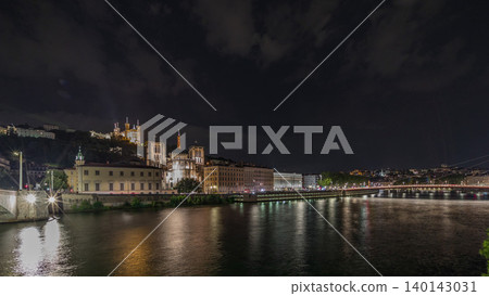 Panorama showing night timelapse of Lyon's cityscape with the red suspension footbridge over the Saone River. France Panorama showing night timelapse of Lyon's cityscape with the red suspension footbridge over the Saone River. France 140143031