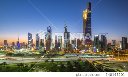 Skyline with Skyscrapers day to night timelapse in Kuwait City downtown illuminated at dusk. Kuwait City, Middle East Skyline with Skyscrapers day to night timelapse in Kuwait City downtown illuminated at dusk. Kuwait City, Middle East 140143201