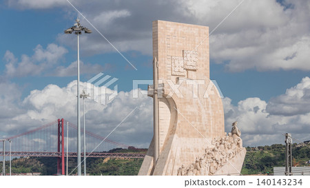 Monument of the Discoveries aerial timelapse, stone memorial and red 25 de Abril Bridge. Lisbon, Portugal 140143234