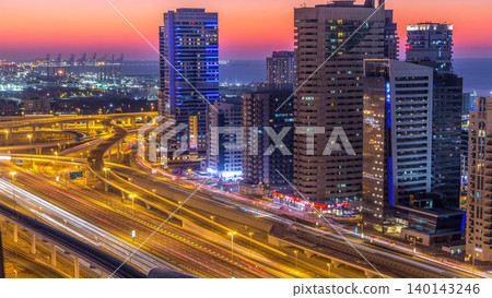 Dubai marina with traffic on sheikh zayed road panorama day to night timelapse lights turn on. Dubai marina with traffic on sheikh zayed road panorama day to night timelapse lights turn on. 140143246