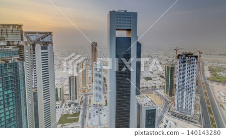 Skyscrapers at sunset timelapse in the skyline of commercial center of Doha, the capital Qatar Skyscrapers at sunset timelapse in the skyline of commercial center of Doha, the capital Qatar 140143280