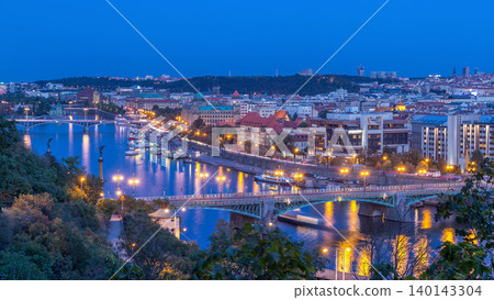 Aerial evening view of the Vltava River and illuminated bridges day to night timelapse, Prague Aerial evening view of the Vltava River and illuminated bridges day to night timelapse, Prague 140143304