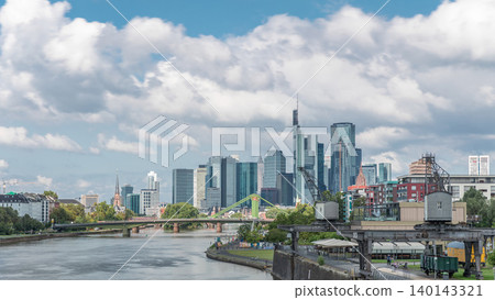 Hyperlapse of Frankfurt's Main Iron Footbridge against the financial district skyscrapers skyline on a sunny day with clouds timelapse. Frankfurt, Germany Hyperlapse of Frankfurt's Main Iron Footbridge against the financial district skyscrapers skyline on a sunny day with clouds timelapse. Frankfurt, Germany 140143321